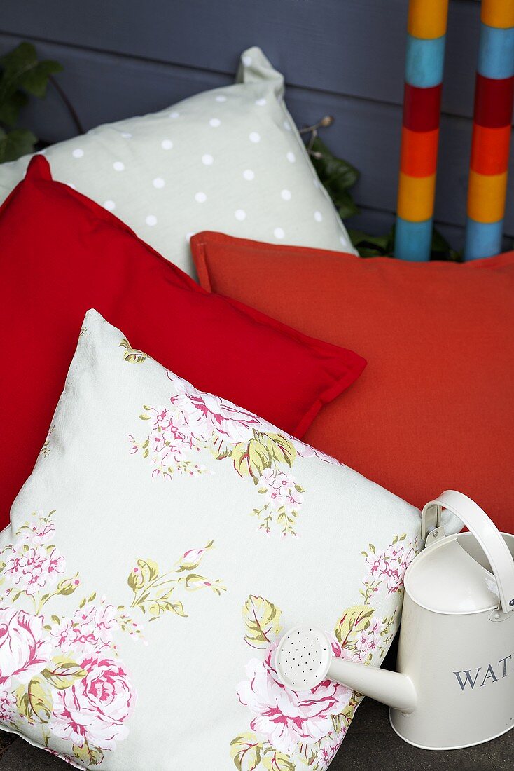 Decorative cushions and small watering can