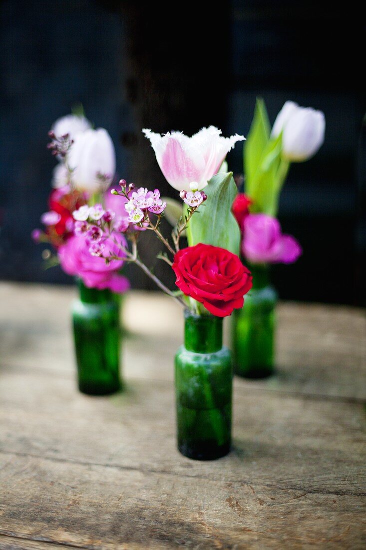 Bunches of flowers in small bottles