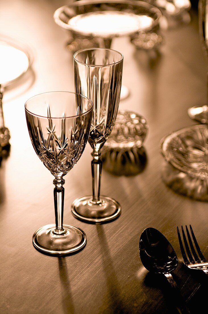 Crystal glasses, crystal bowls and cutlery on a table