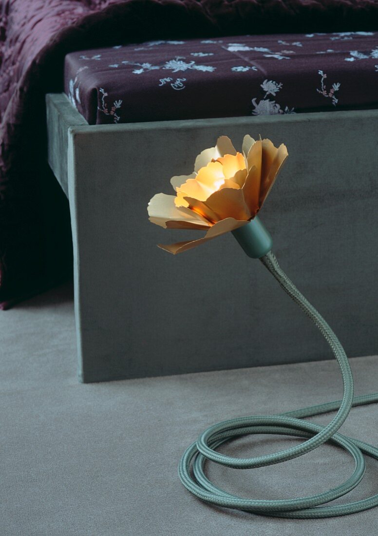 Tischleuchte in Blütenform mit verstellbarem Fuss am Bettende