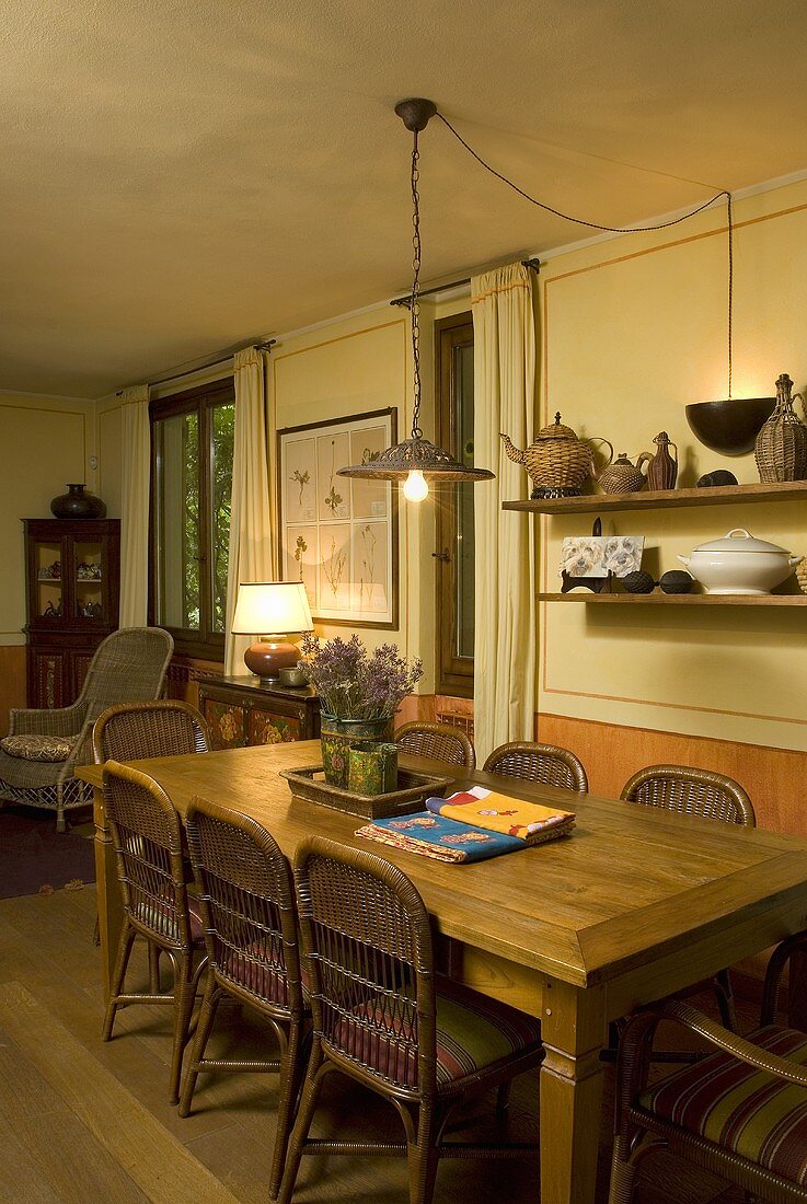 Wooden table with wicker chairs in a country style dining area