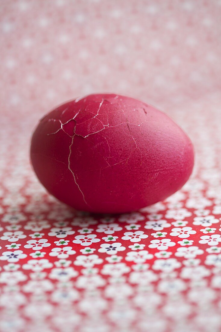 A broken, red Easter egg (close-up)