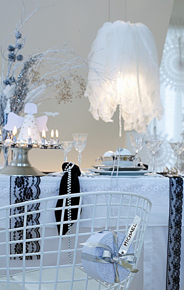 A dining table decorated for Christmas in black and white