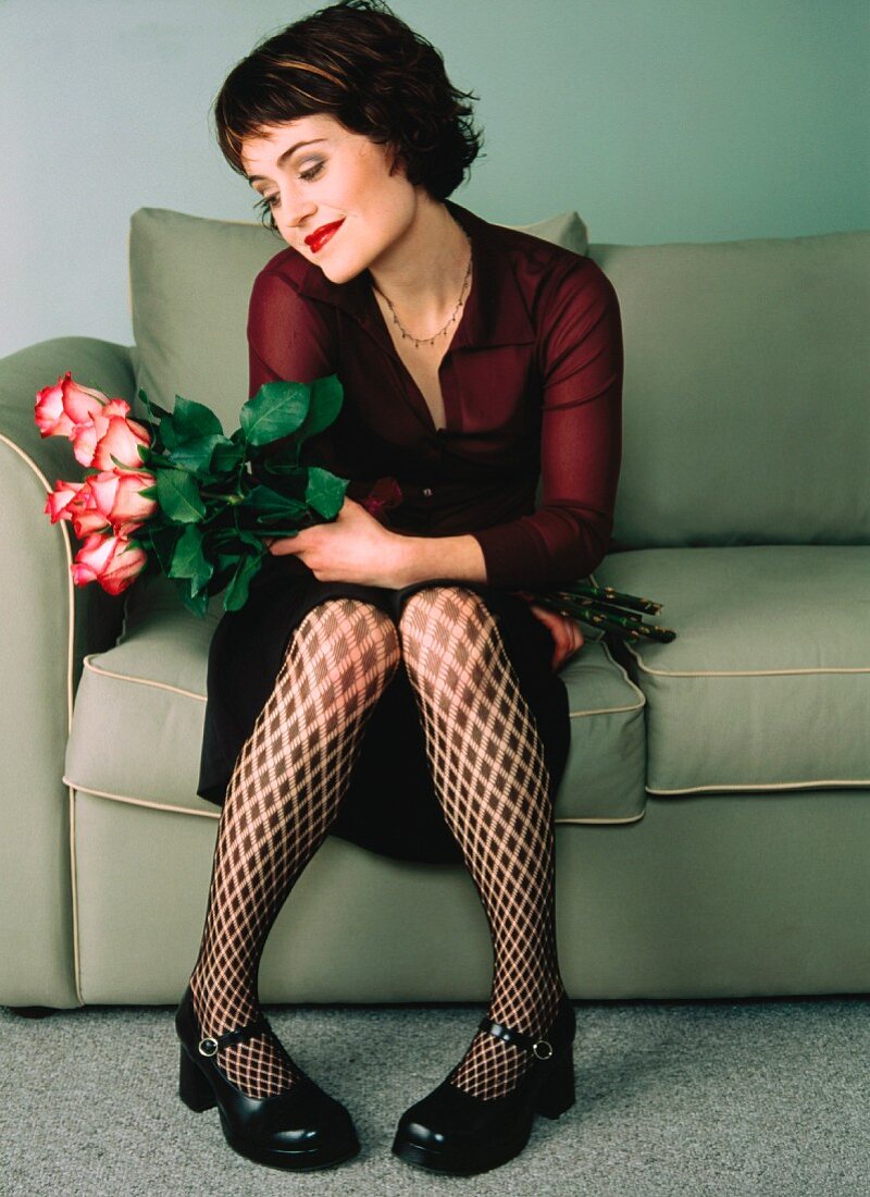 Woman with roses on couch