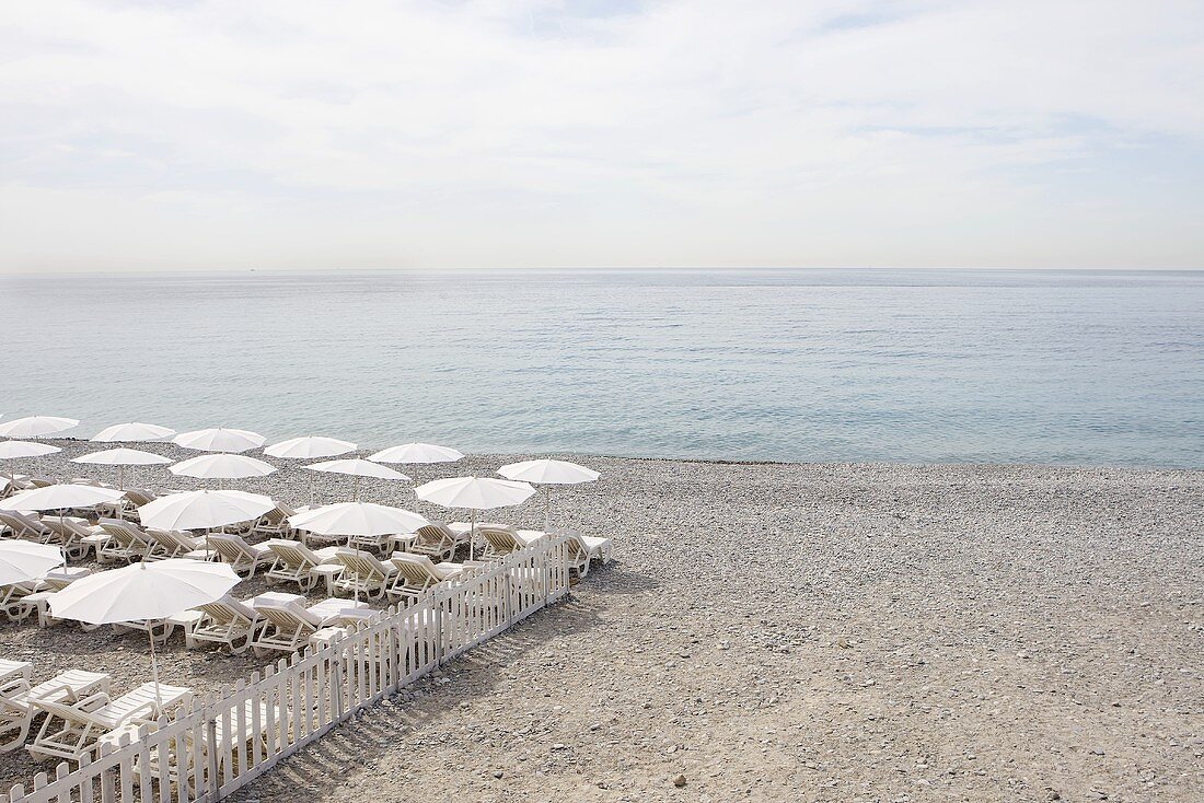 Chairs and Umbrellas Set Up on Beach; Nice, France