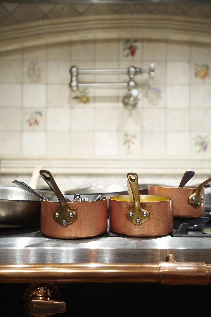 Various Copper Pots on Oven