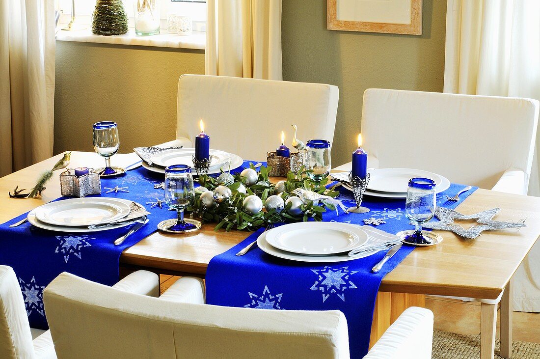 A festively decorated dining table with blue table runners