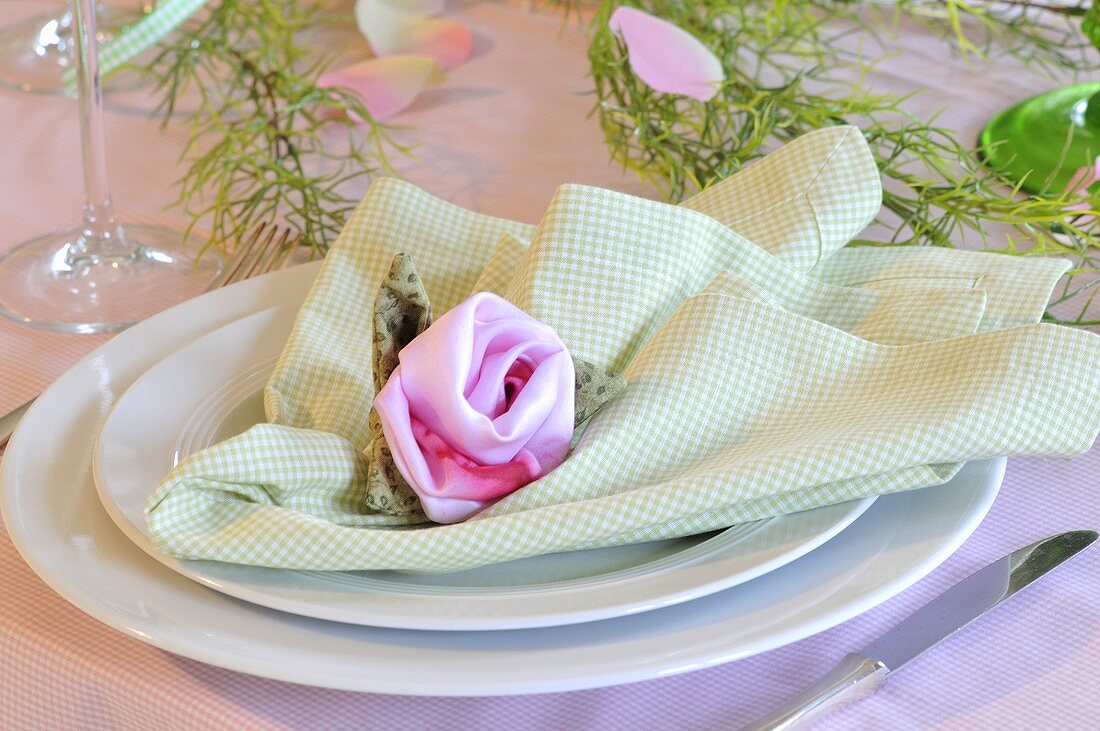 A place setting decorated with flowers on a napkin