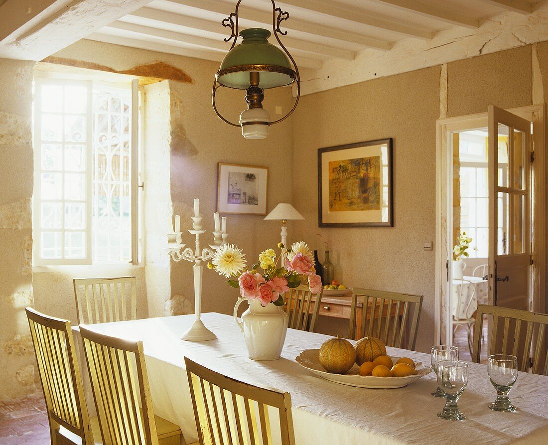 A long table in a dining room of a country house