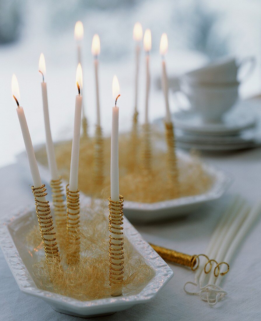Candles wrapped in gold thread with tinsel