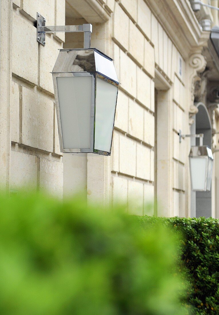 Elegant lamps attached to a white stone facade