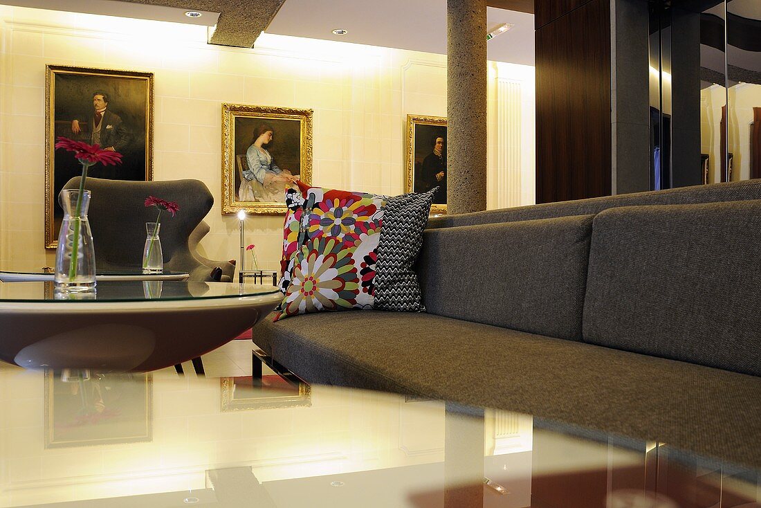 A grey sofa with colourful cushions in an elegant hotel reception
