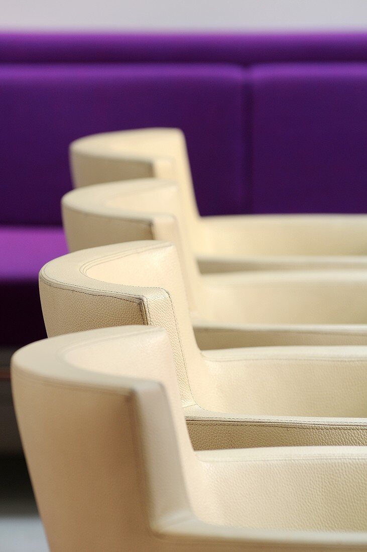 Detail of a row of white leather chairs