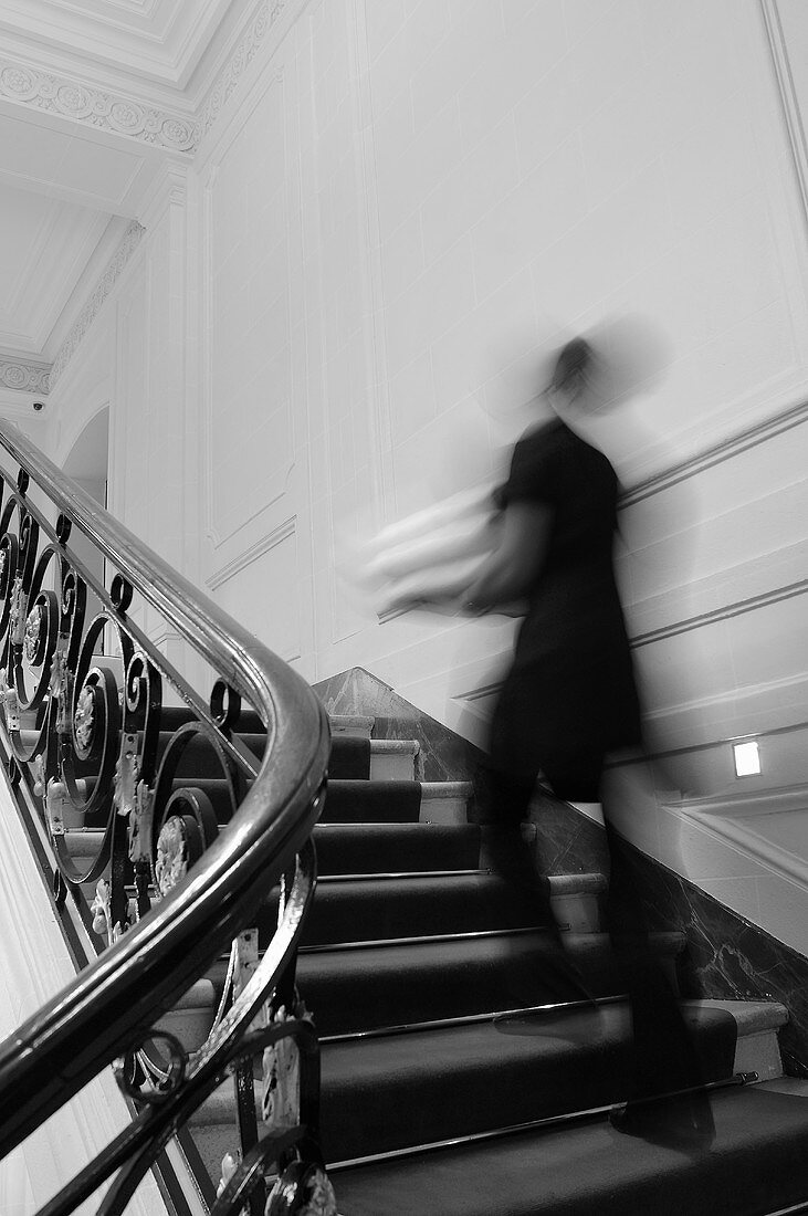 Someone running up the stairs in an elegant house