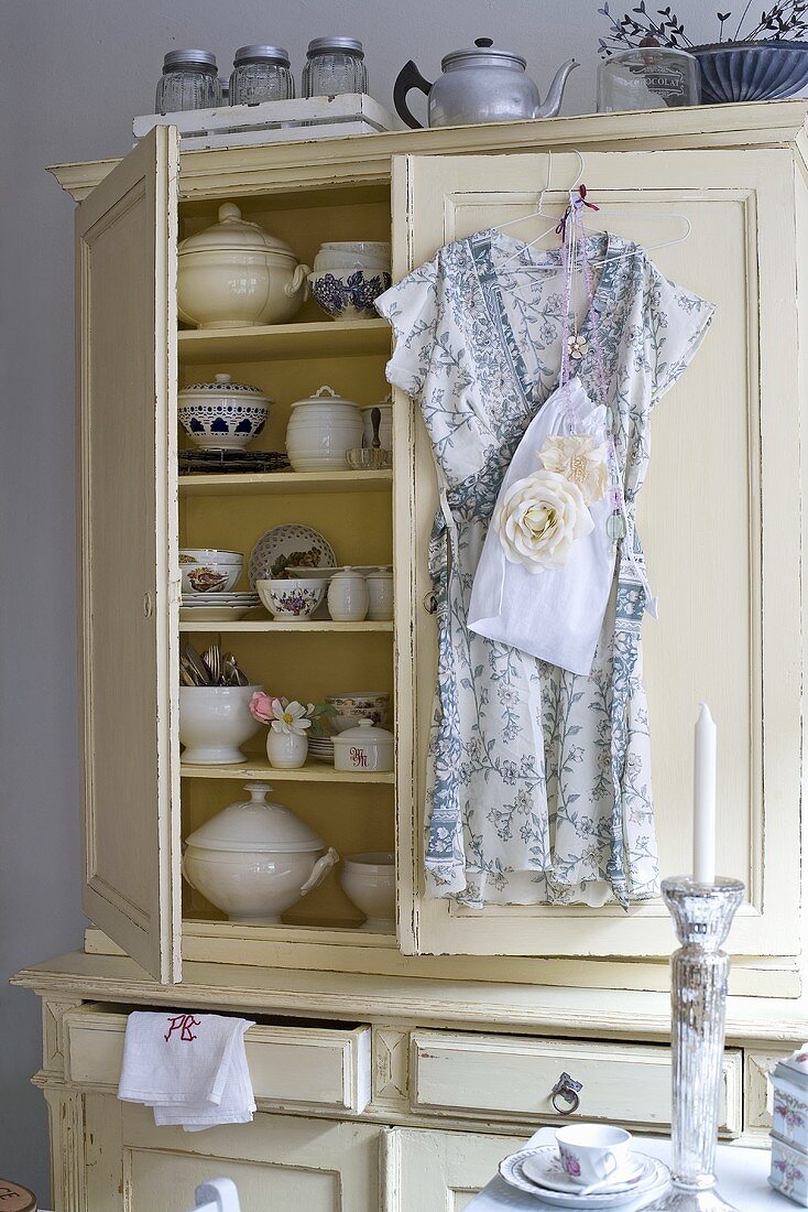 Country style crockery cupboard with the doors ajar