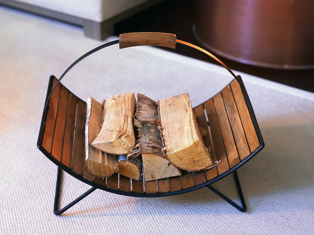Wooden basket with a metal frame and firewood