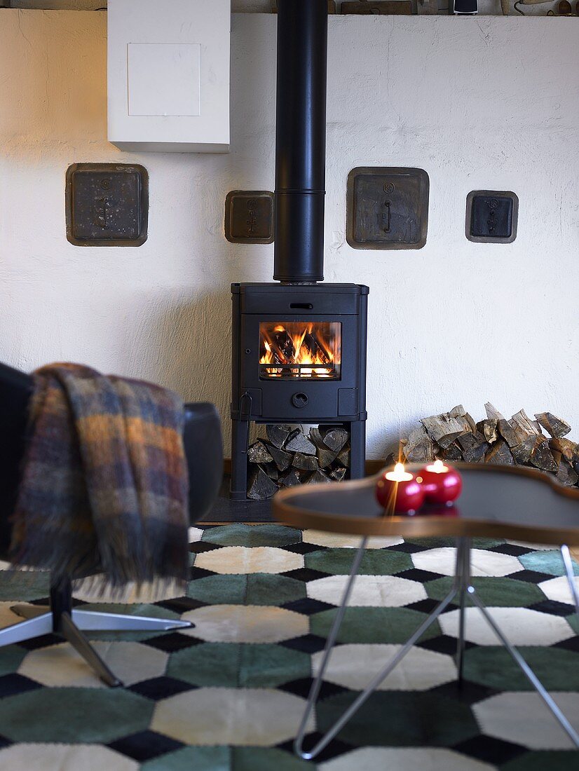 Wood burning stove with a fire in a living room