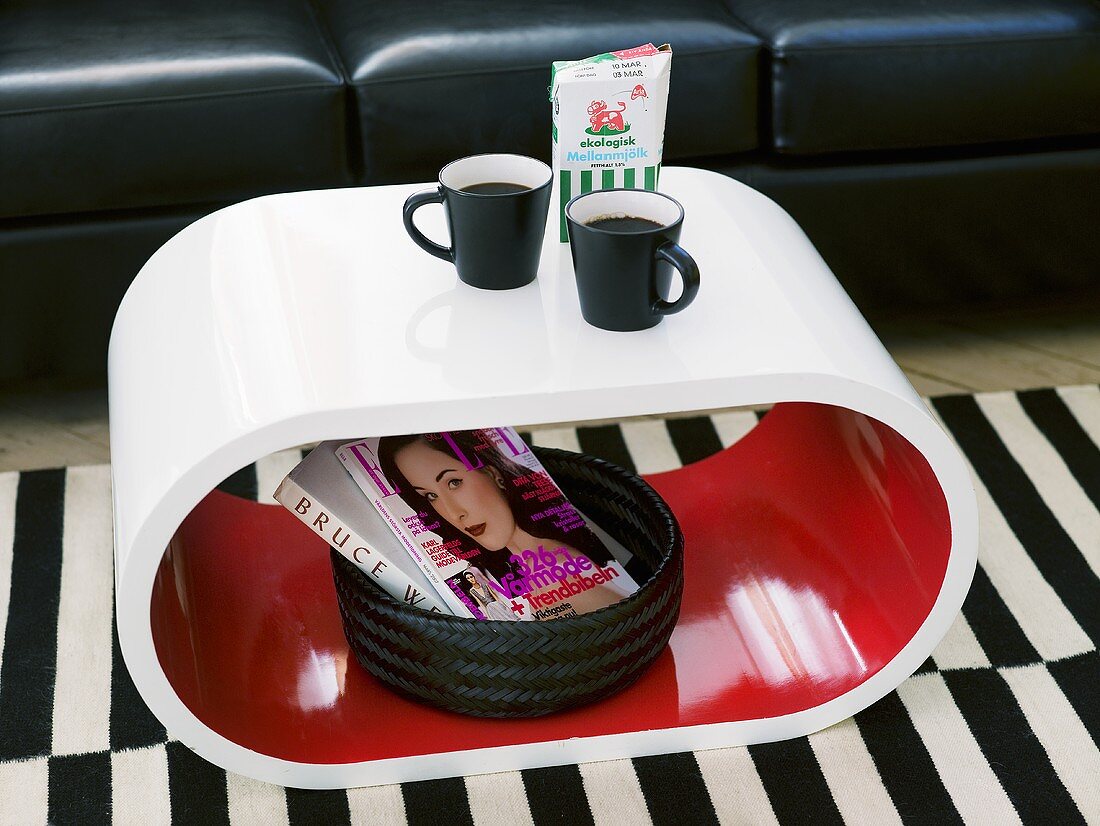 Coffee break on a side table (oval shaped) with a magazine holder