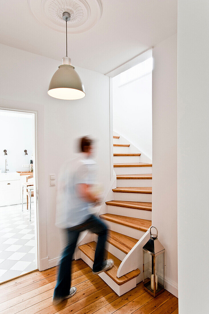 Man walking up the stairs, House furnished in country style, Hamburg, Germany