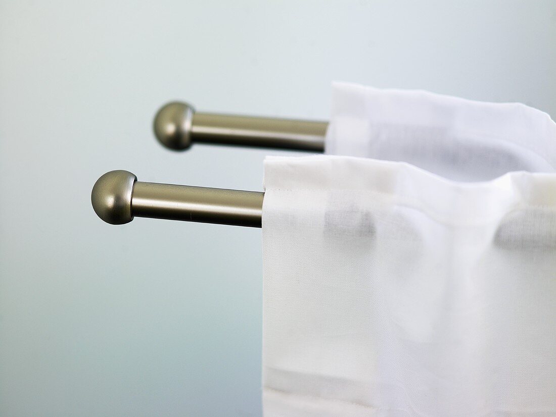 White curtains on stainless steel curtain rods