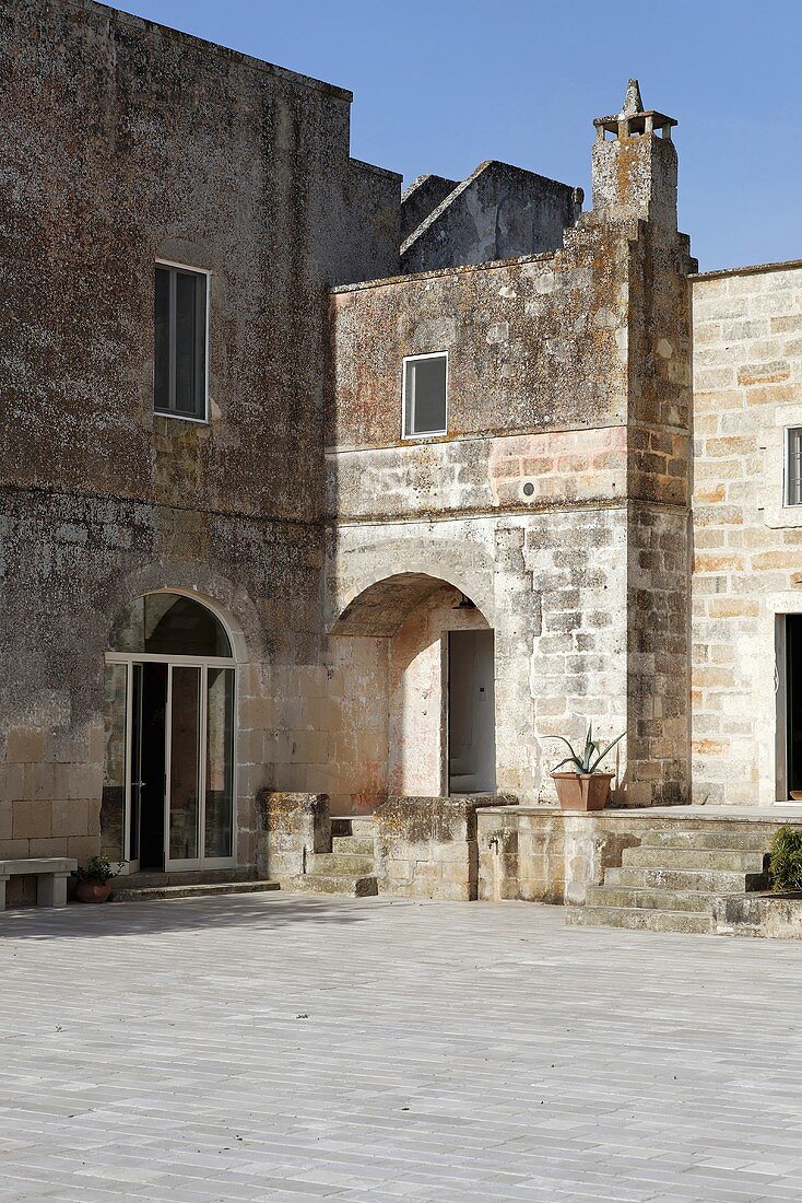 Mediterranean houses with natural stone walls and a paved piazza