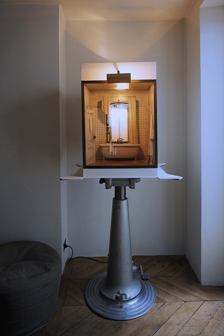Miniature model of a bathroom on an adjustable display stand in a window niche