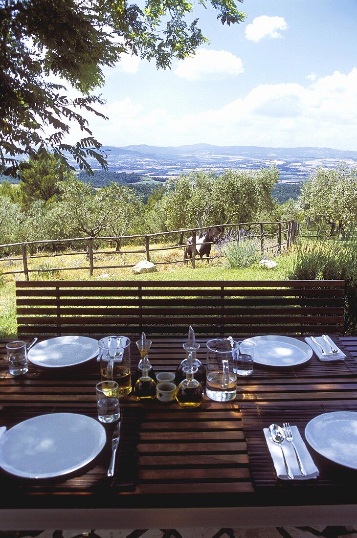 Set table on a terrace with a view of the Mediterranean countryside