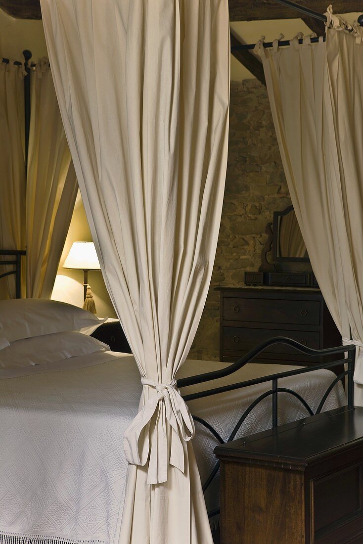 Canopy bed with fabric drapes