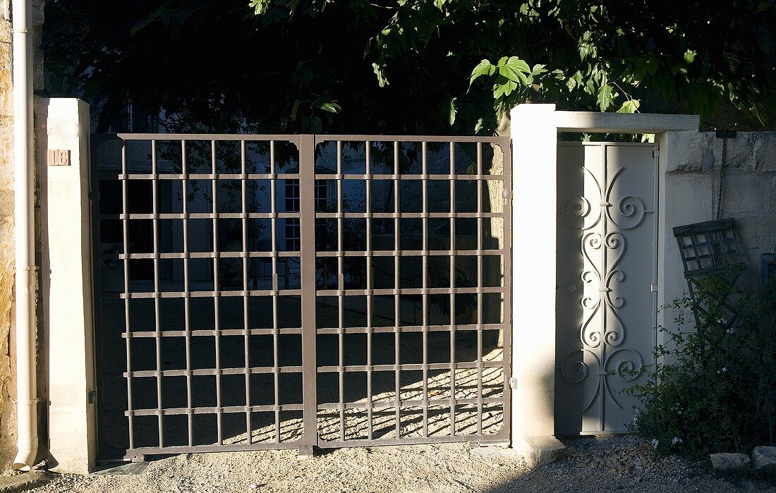 Garden gate made of gray metal grillwork