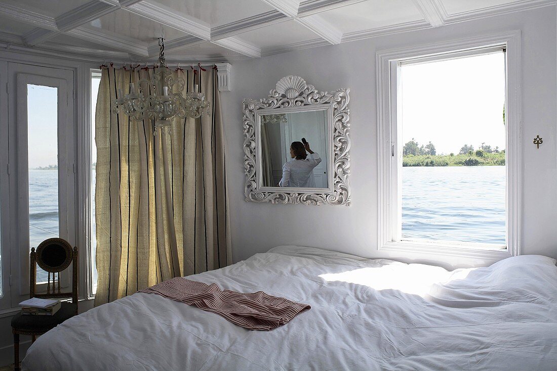 Romantisch gestalteter Schlafraum auf dem Boot und Blick auf die Flusslandschaft, Nil, Ägypten
