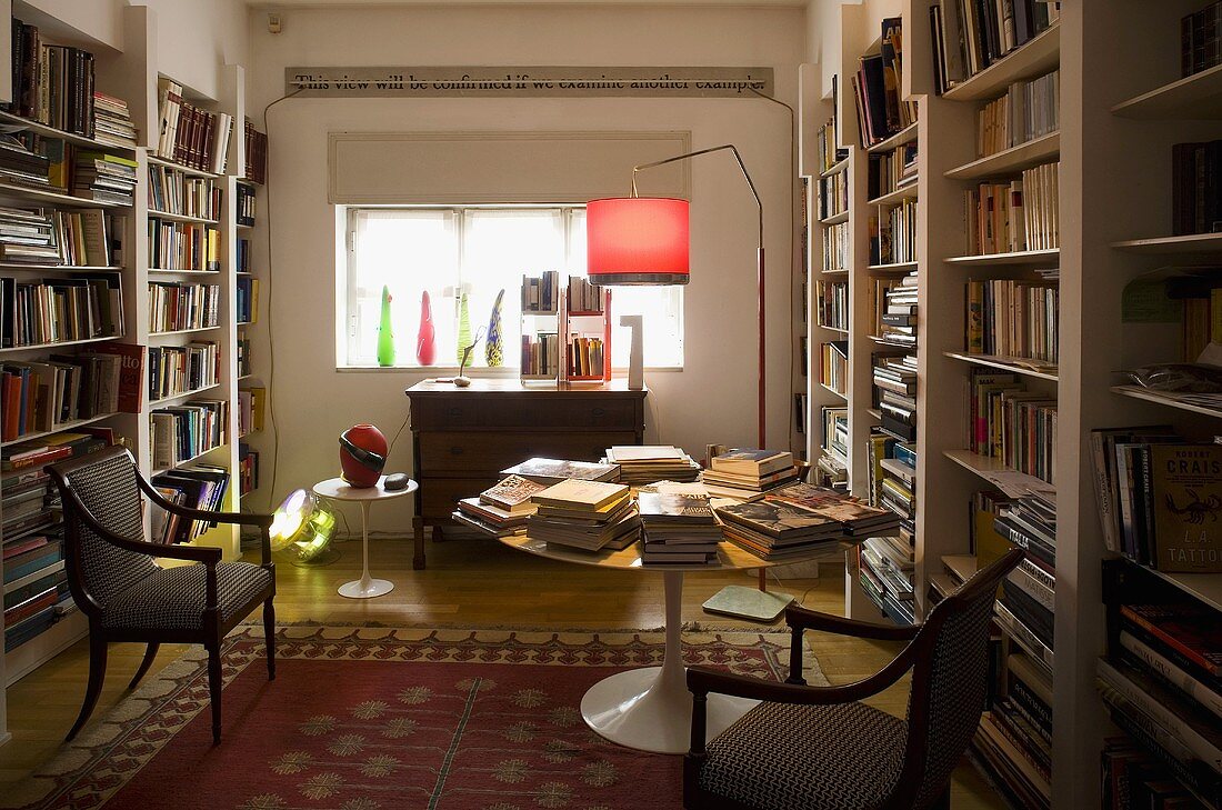 Library with white built-in shelves and antique chairs