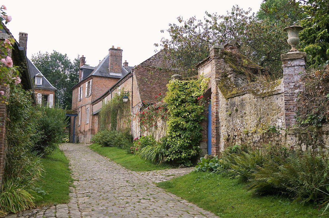 A brick-built town house and a stone wall on a old village street
