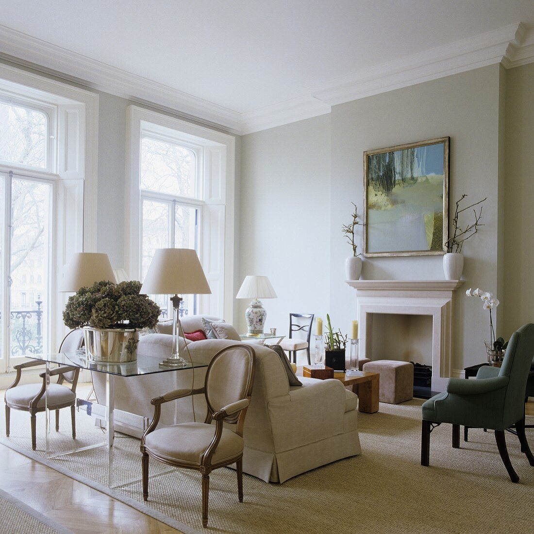 A classic English living room with grey wall and a light coloured sofa in front of a fireplace
