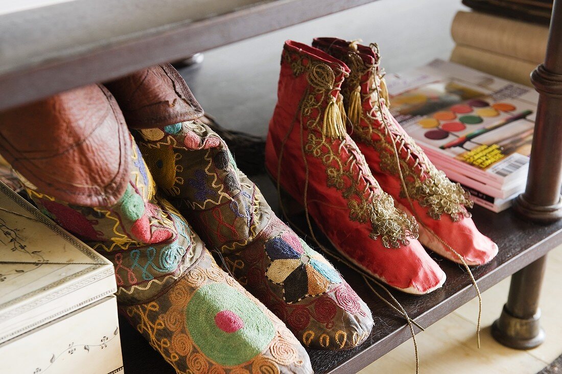 Hand-made, embroidered fabric shoes from Afghanistan on a shelf