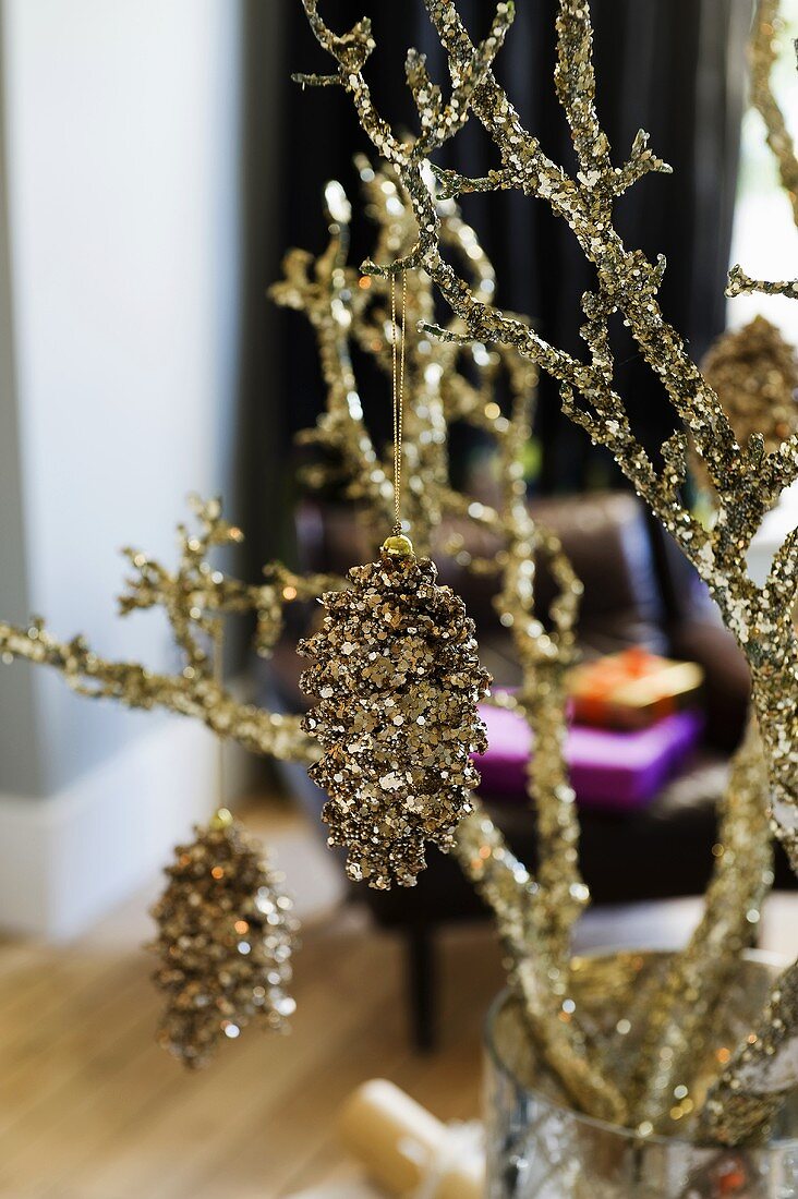 Gilded Christmas decorations on golden branch