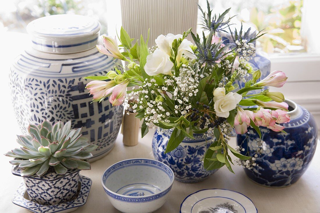 Blue and white Chinese bowls and pots with flowers