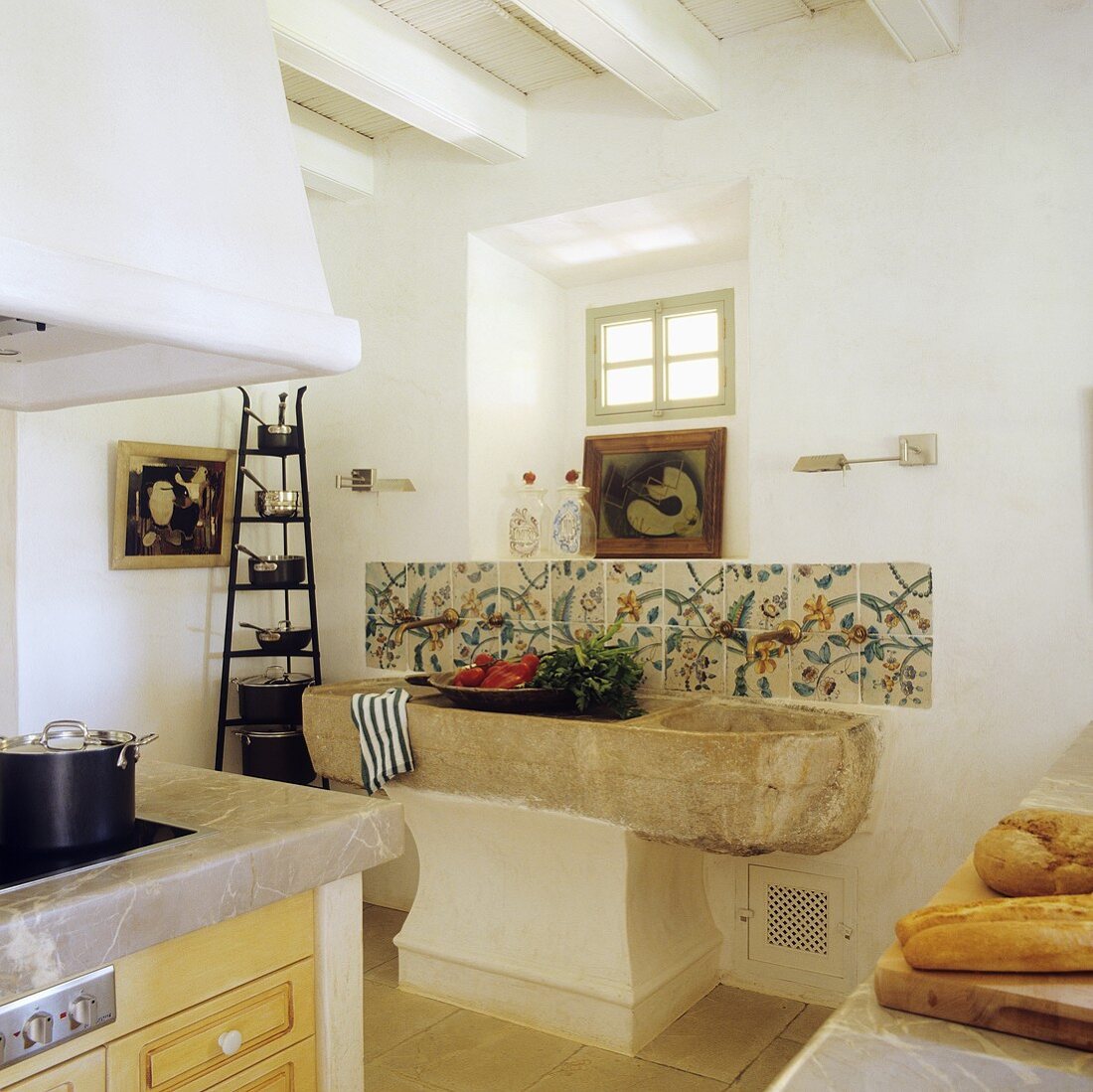 A rustic stone sink in the kitchen of a Spanish country house
