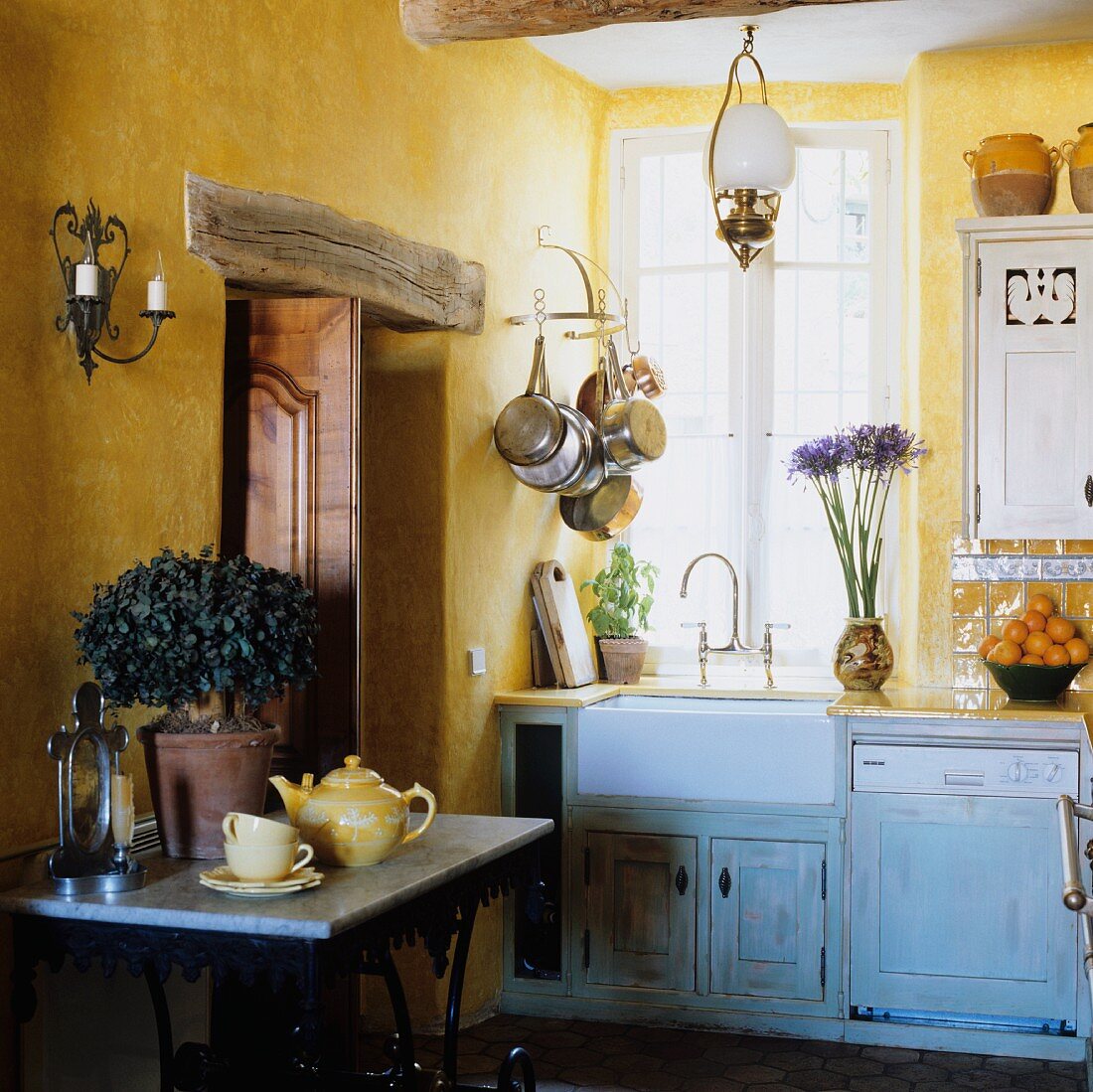 A corner of a country house kitchen with yellow walls