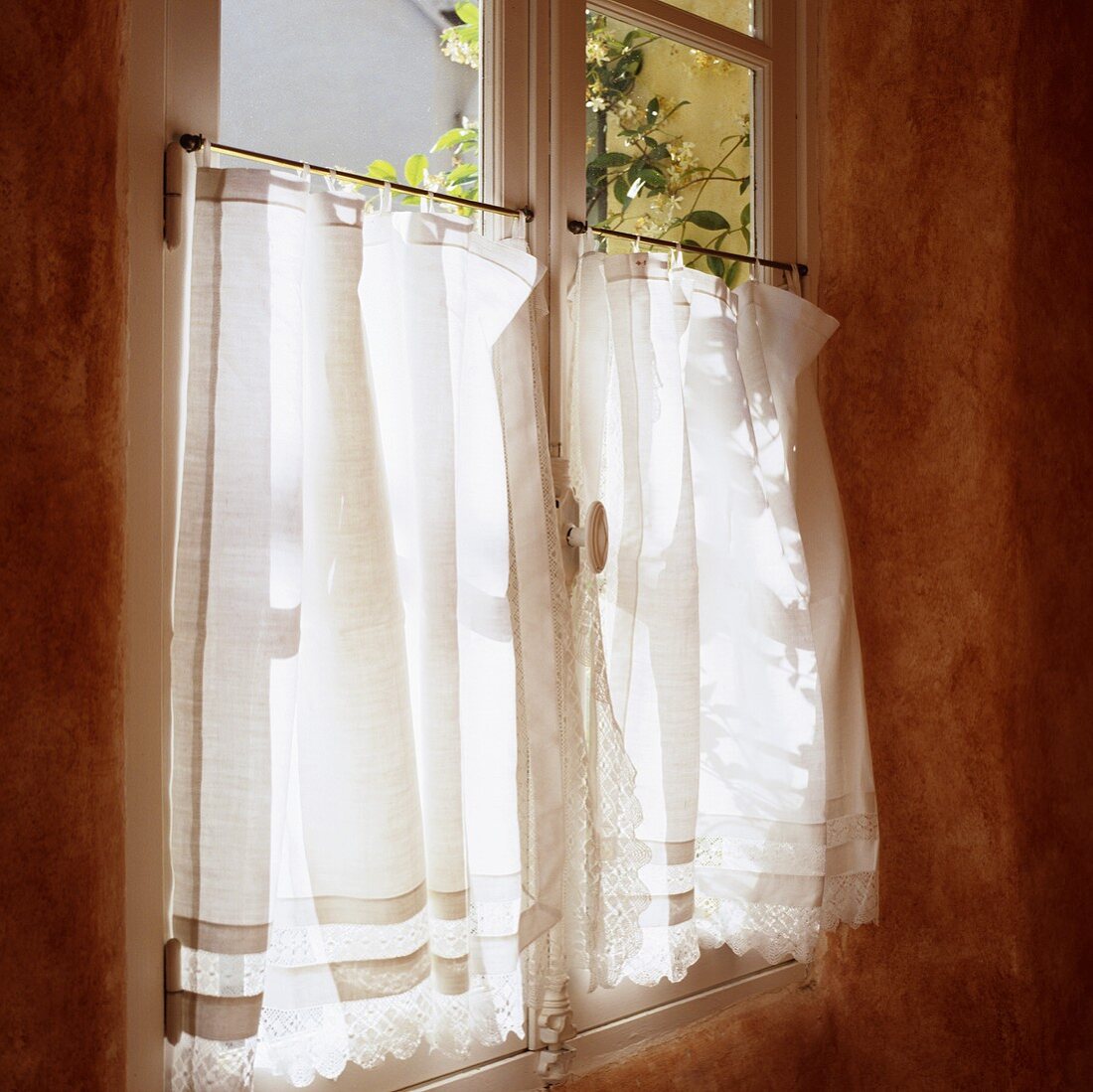 A white curtain at a window