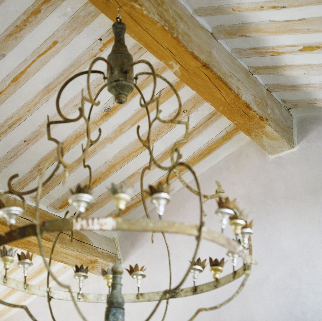 A wood beamed ceiling with a chandelier