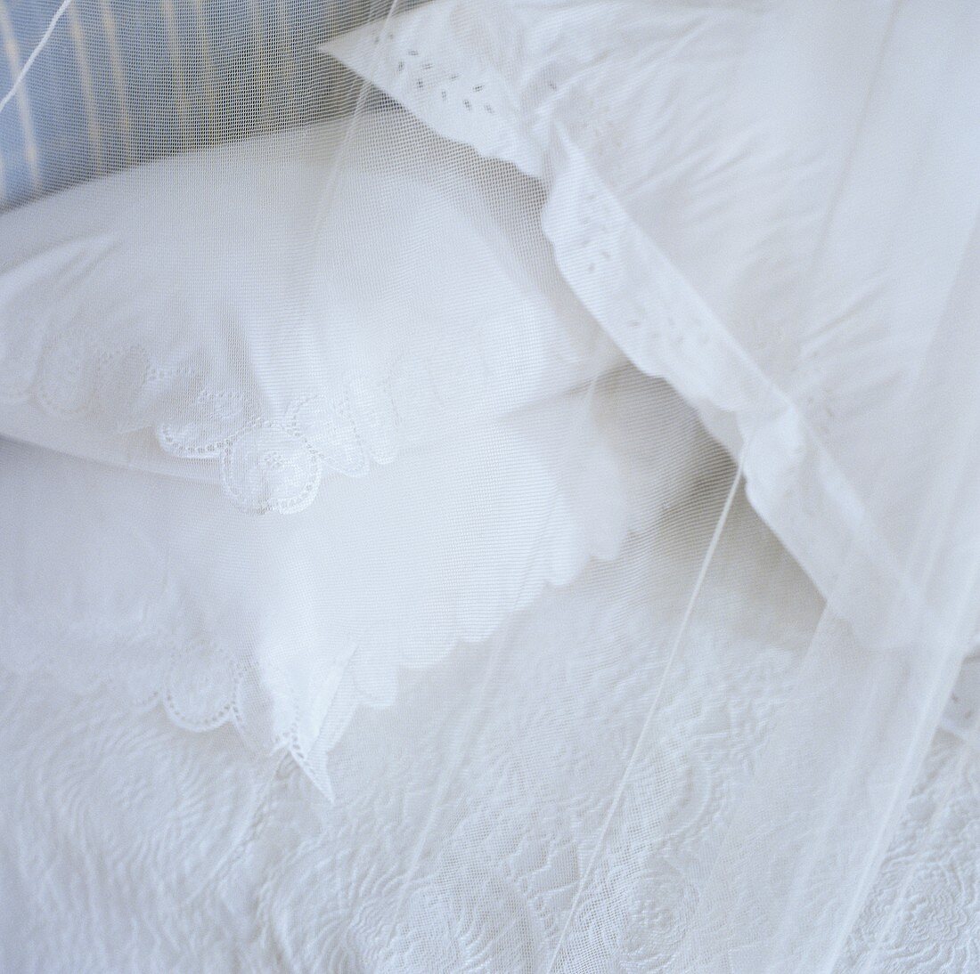 A white cushion with a lace border