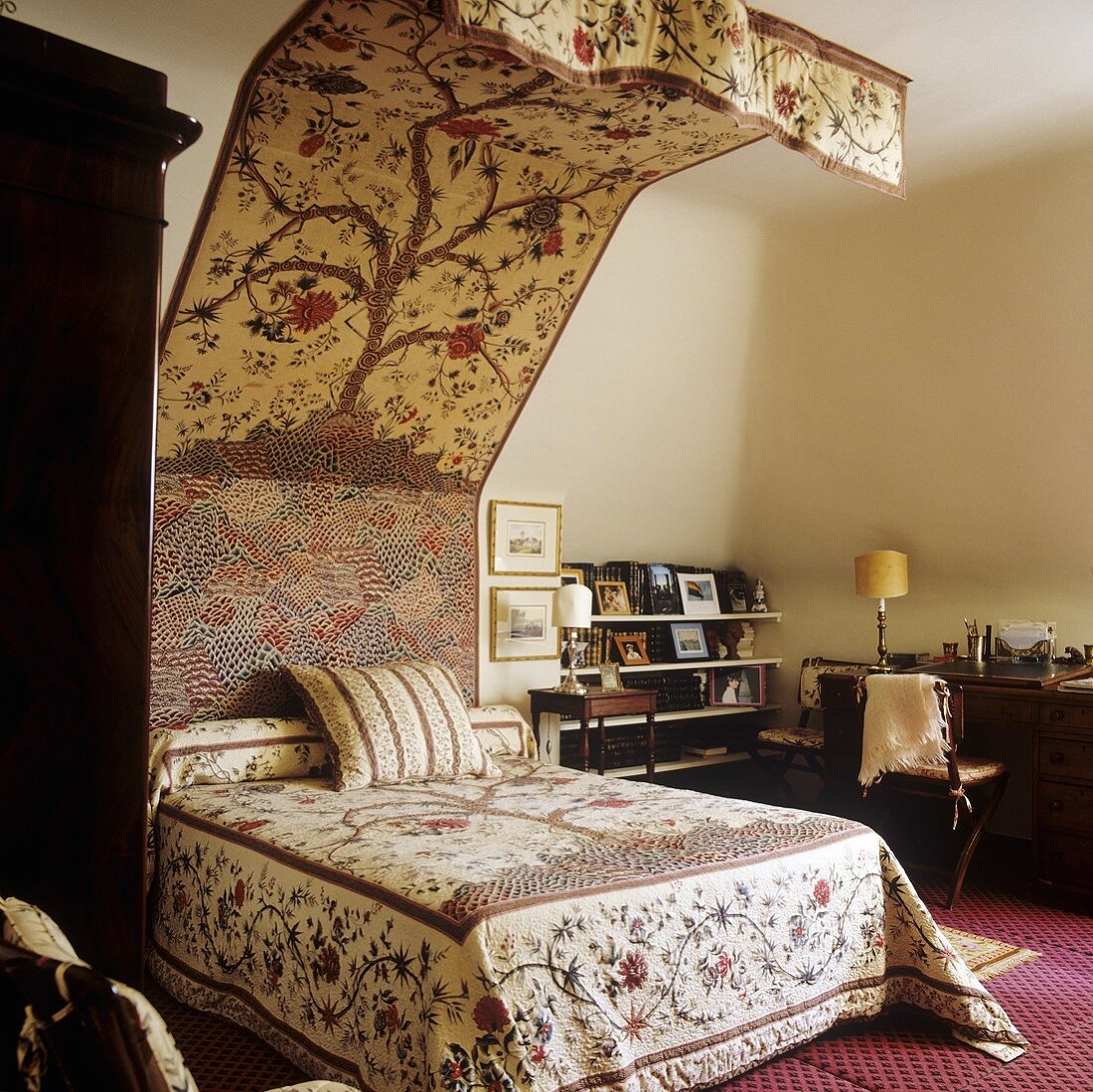 A queen-sized bed and a canopy with the same floral patterned fabric