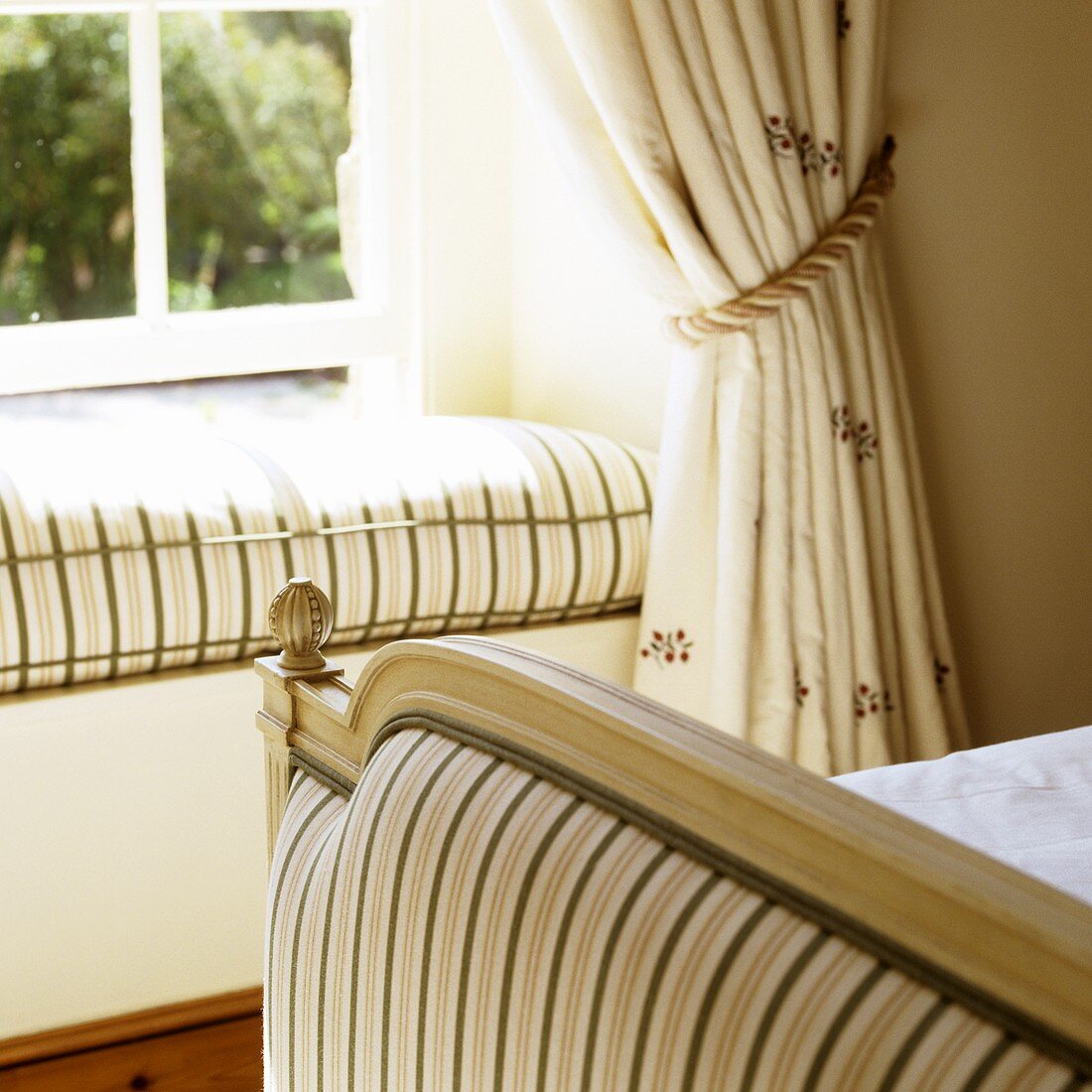 A window sill with a cushion in the bedroom of a country house