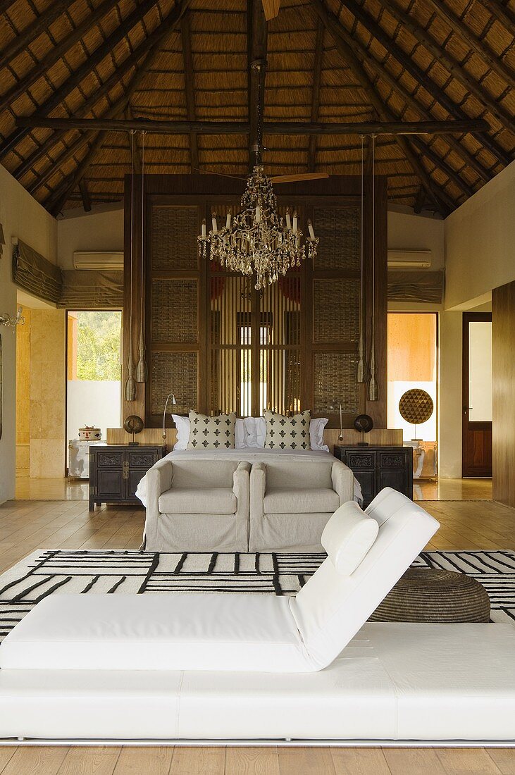 A large bedroom with a white floor lounger in a South African house