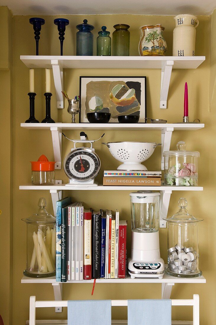 A kitchen shelf on a yellow-painted wall