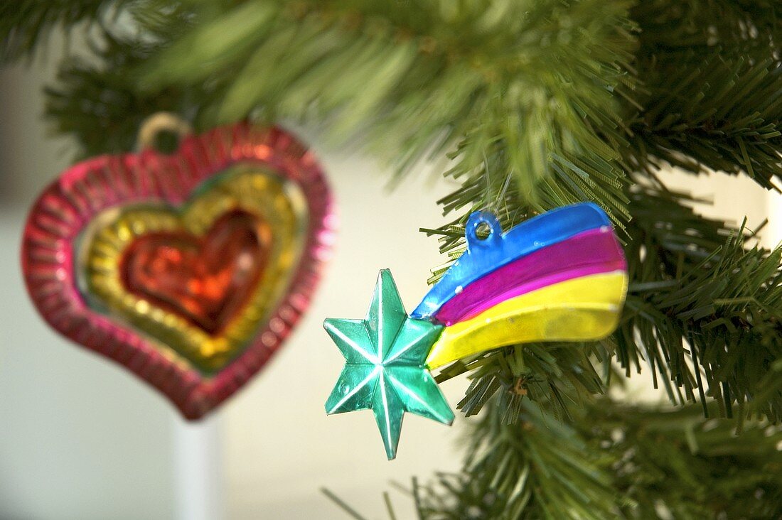 Colourful metal Christmas decorations on a Christmas tree