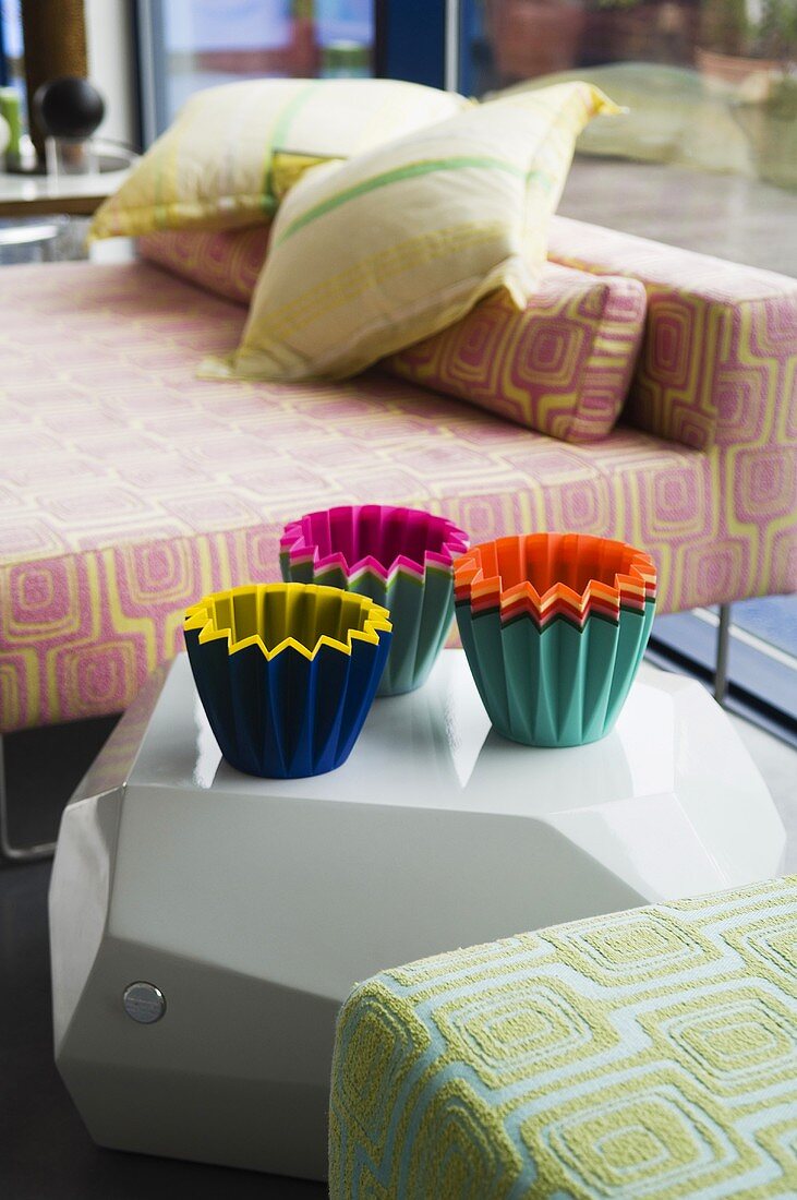 Colorful containers between upholstered furniture