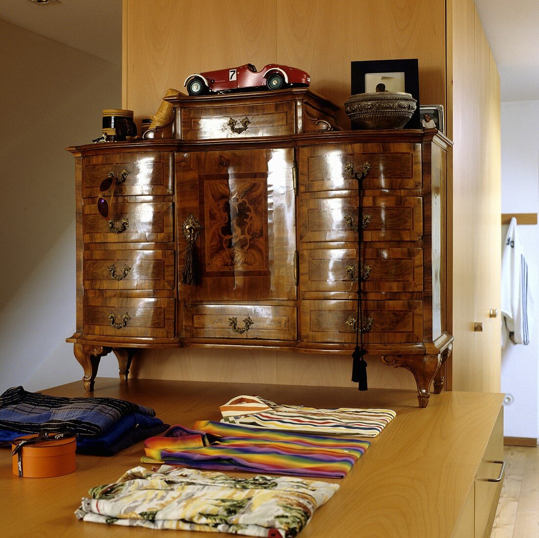 A Baroque chest of drawers on a pedestal with a play of light