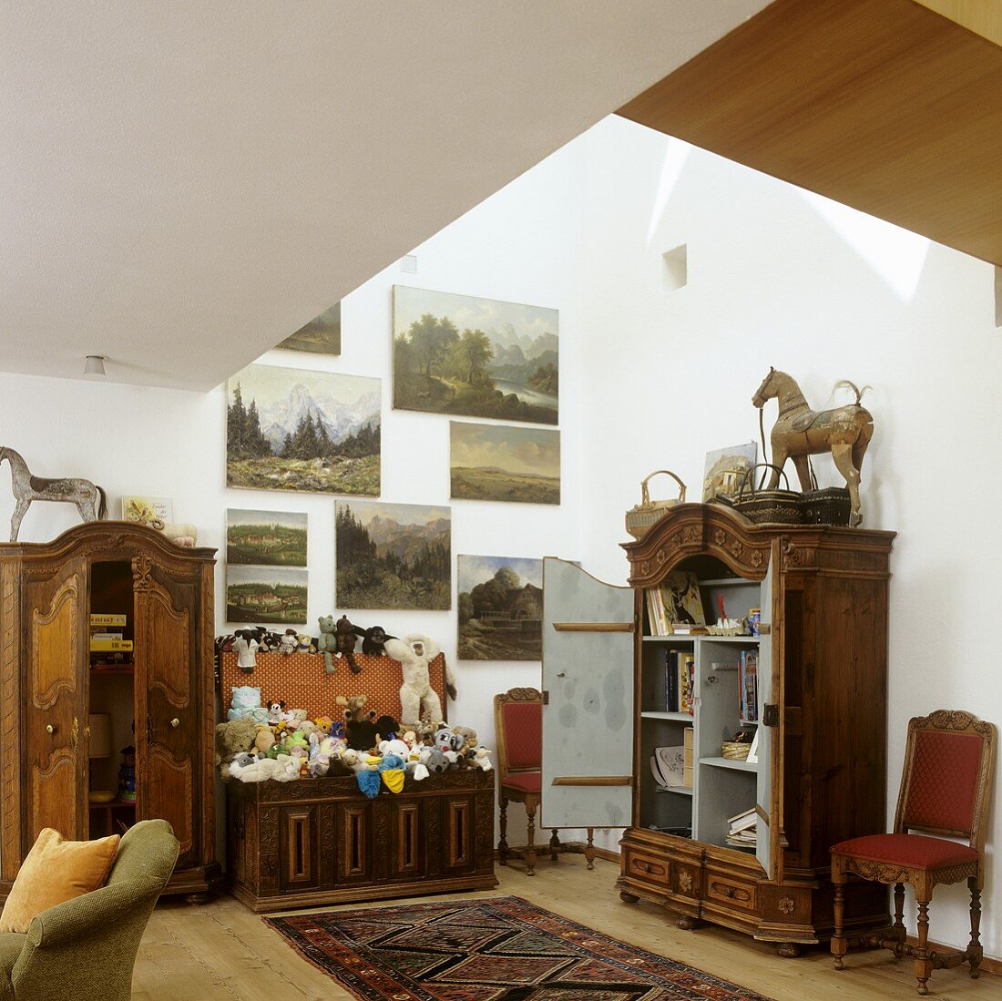 A collection of antique furniture and paintings in the attic of a house