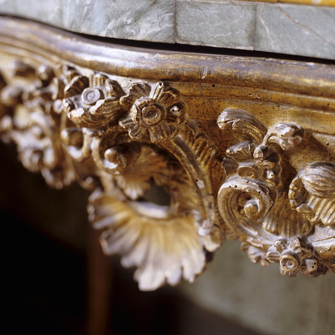 Detail of a wooden table - a hand carved floral design